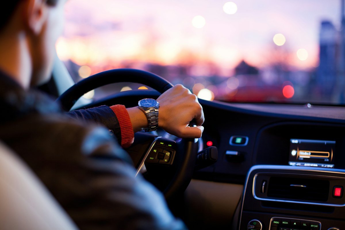 Driver behind the wheel in evening traffic